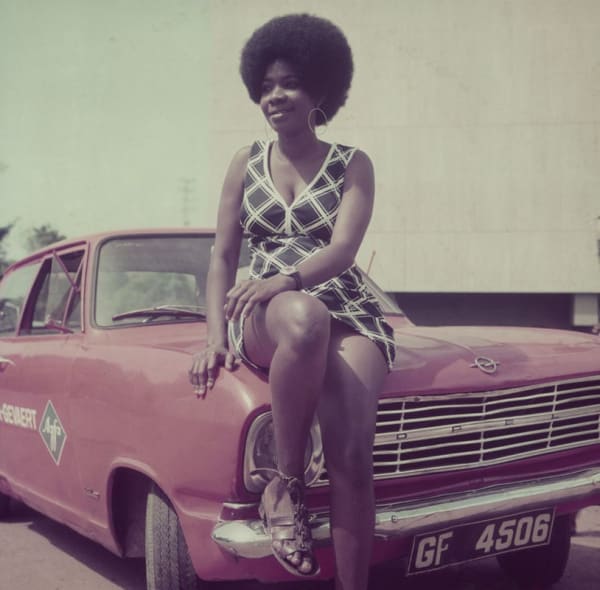 Woman posing on James Barnor's car, Accra