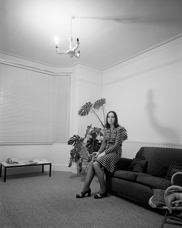 Woman in striped dress seated