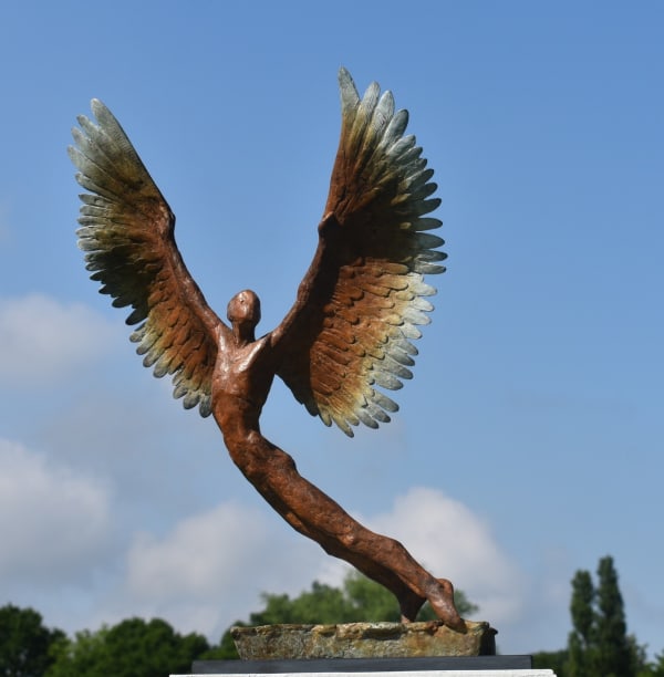Figurative bronze sculpture of mythical Greek winged figure Icarus by Nicola Godden, displayed on plinth.