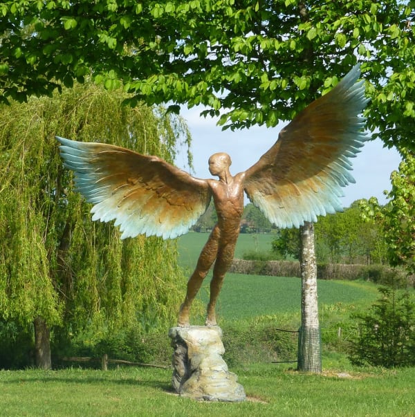 Bronze resin sculpture of mythical Greek winged figure Icarus by Nicola Godden, displayed on integral stone plinth