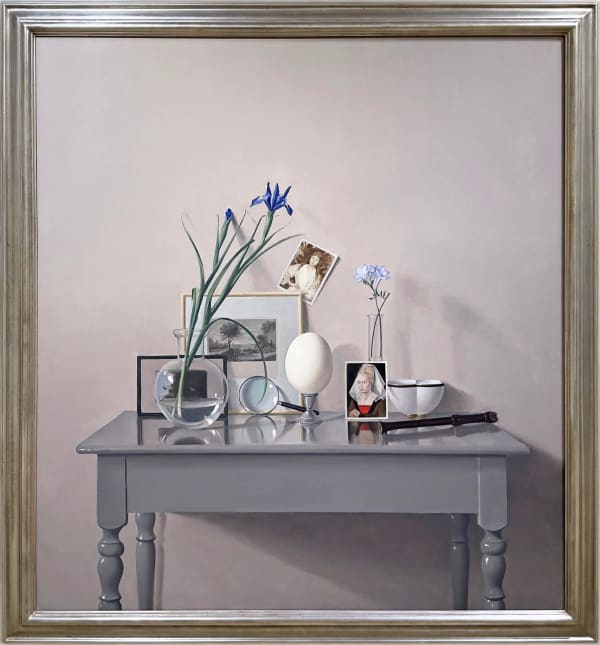 Still life with a table and an ostrich egg, photographs, and plants