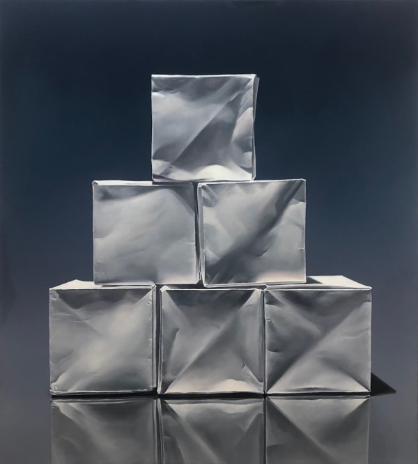 Pyramid of origami paper boxes before dark blue background