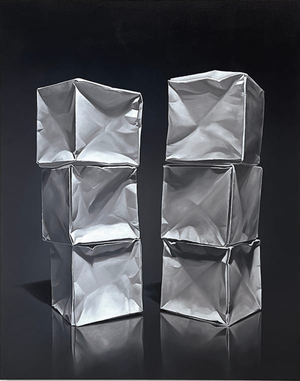 Two origami paper cube columns before black background