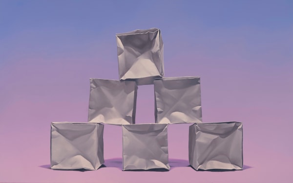 Spaced pyramid of origami paper cubes before a pink and purple background