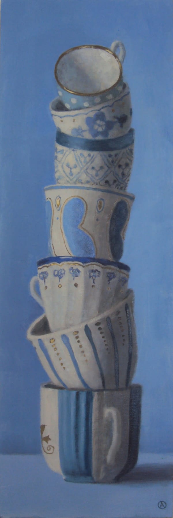 painted stack of tea cups on blue background