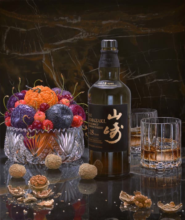 Still life on a tabletop with a Whiskey bottle, two glasses, walnuts, and a fruit bowl