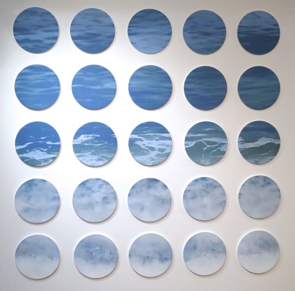 25 circular canvases with blue painting of waves