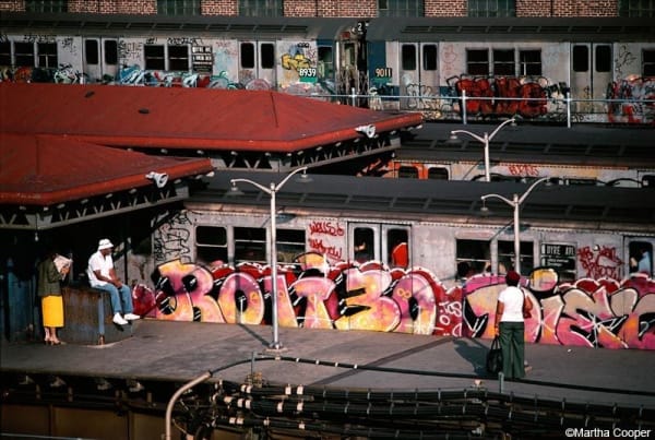 Martha Cooper, Rolio written on a subway car viewed from a Bronx platform, 1981