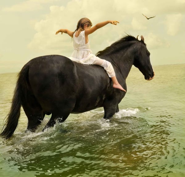 Girl riding horse through water photograph Tom Chambers original prints buy here Sun Valley contemporary art Gilman gallery