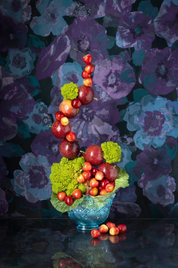 arcing arrangements of cherries and plums in bowl photo by jp terlizzi