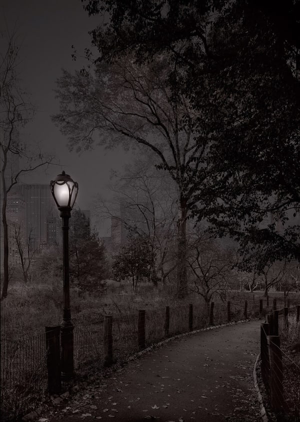 glowing lamp on walkway in the park by michael massaia