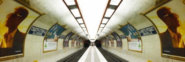 man in sunglass poster along Paris metro walkway photo by Laurie Victor Kay