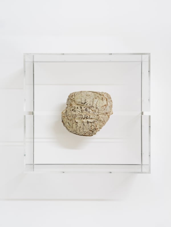 A mixed media piece in a glass case.