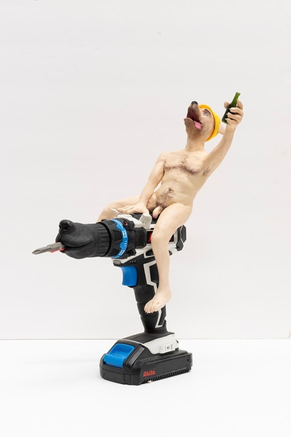 sculpture of nude anthropomorphic dog wearing construction hate and riding electric drill