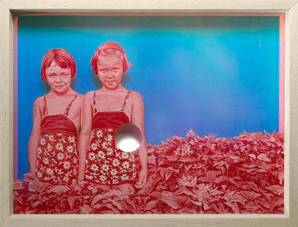 two young girls painted in pink standing in a bush