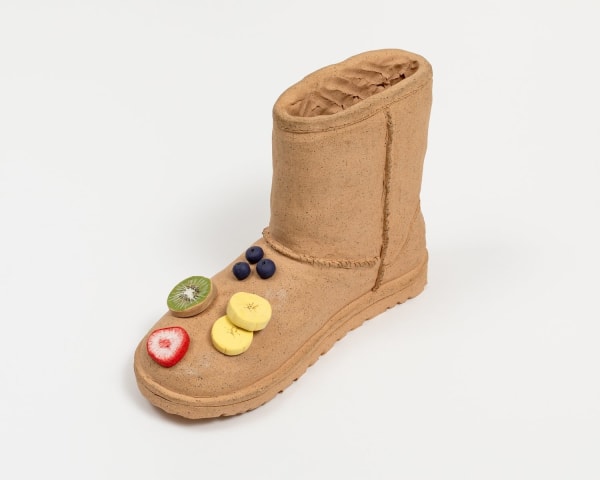 Didi Rojas sculpture of Ugg with fruit on toe