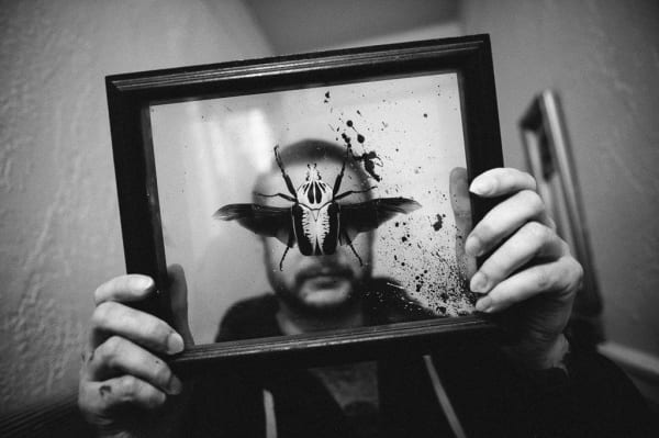 Shaun Roberts photo of male figure holding butterfly in frame