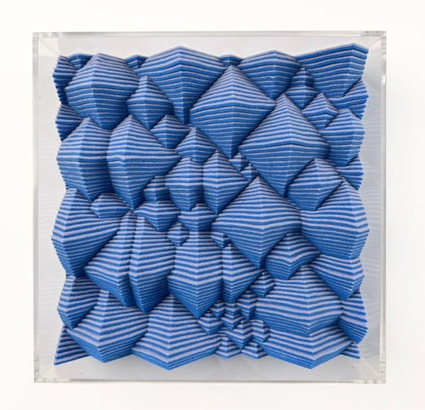 Blue textured square made from felt with a clear acrylic frame