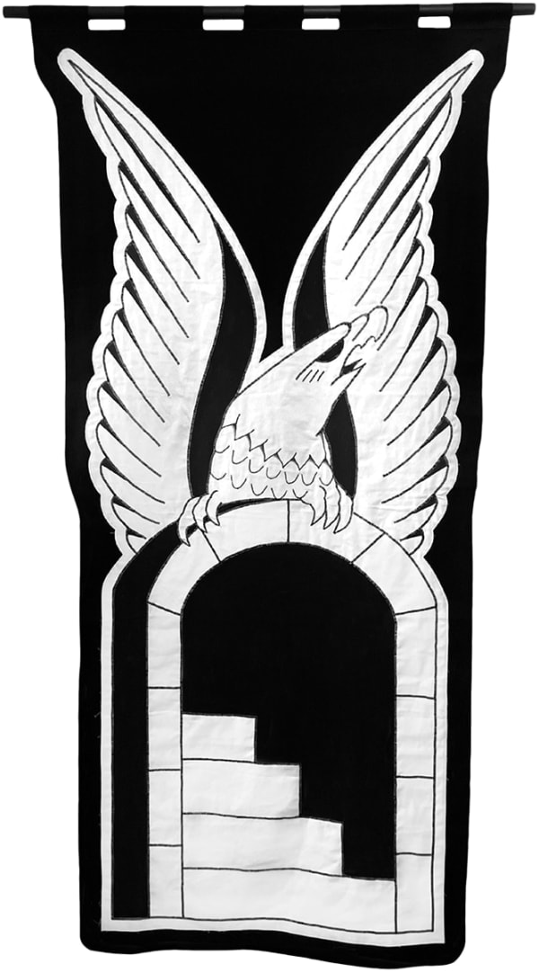 embroidered black and white banner of an eagle over a doorway
