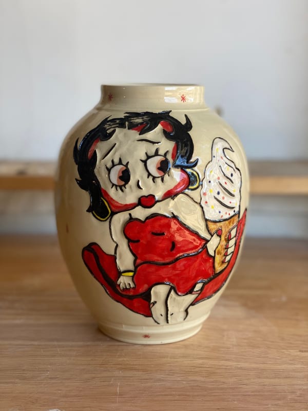 Ceramic vase with Betty Boop character holding a soft served vanilla ice cream cone with sprinkles on top.