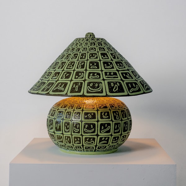 lamp made out of green smiley face ceramic tiles by artist Kyle Daniels