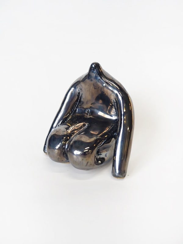 ceramic piece by Jocelyn Tsaih of a silver figure sitting
