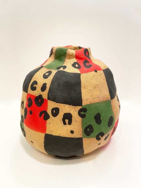 Jackie Brown's vase with cheetah print with green yellow and green shapes and checkers