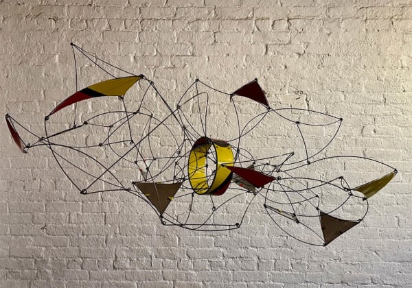 Wire hanging mobile sculpture with colorful panels in red, blue, yellow