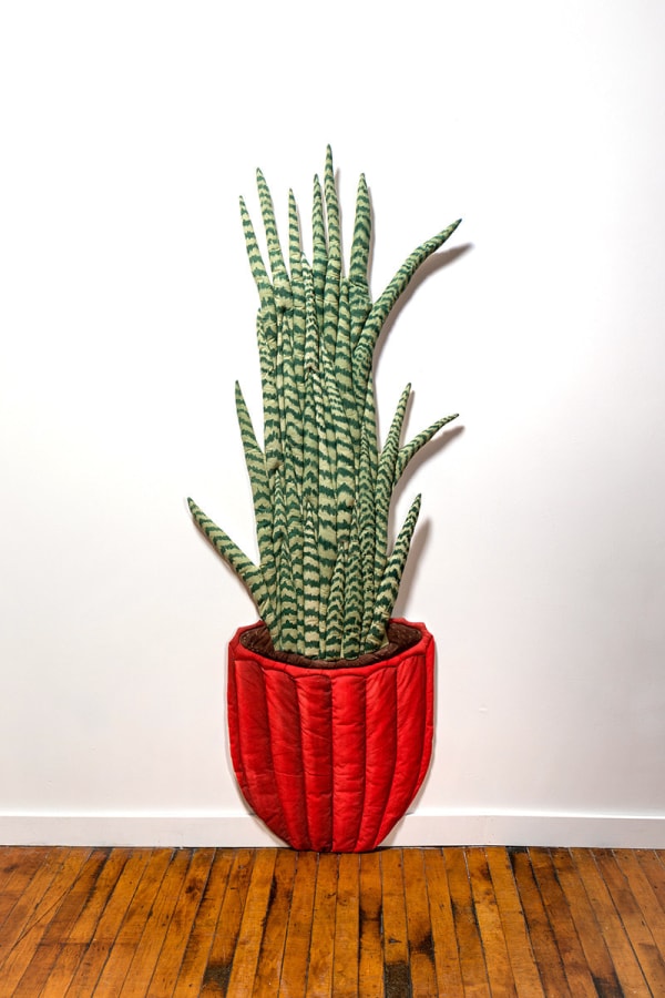 soft sculpture of a tall green plant in a red pot