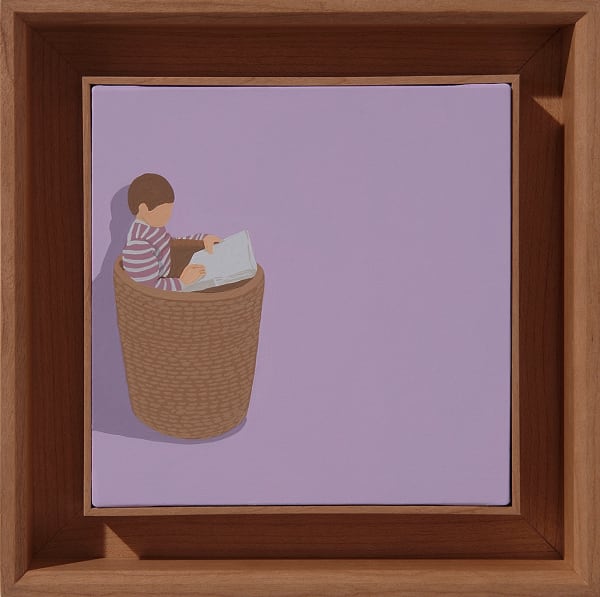 a child sitting in a basket reading with a purple background