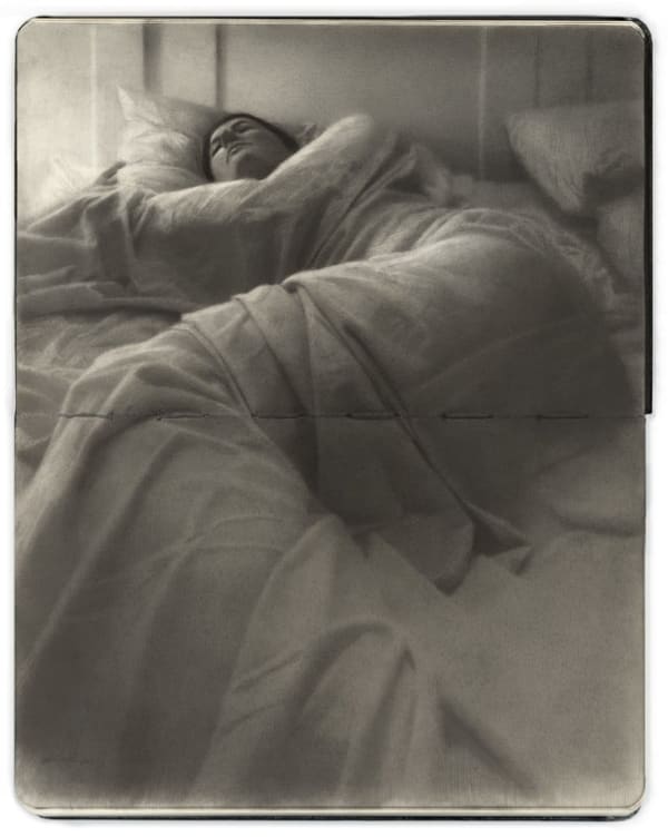 Openface Moleskine notebook with a graphite and charcoal drawing depitcting a woman laying in bed by artist Zachary Oldenkamp