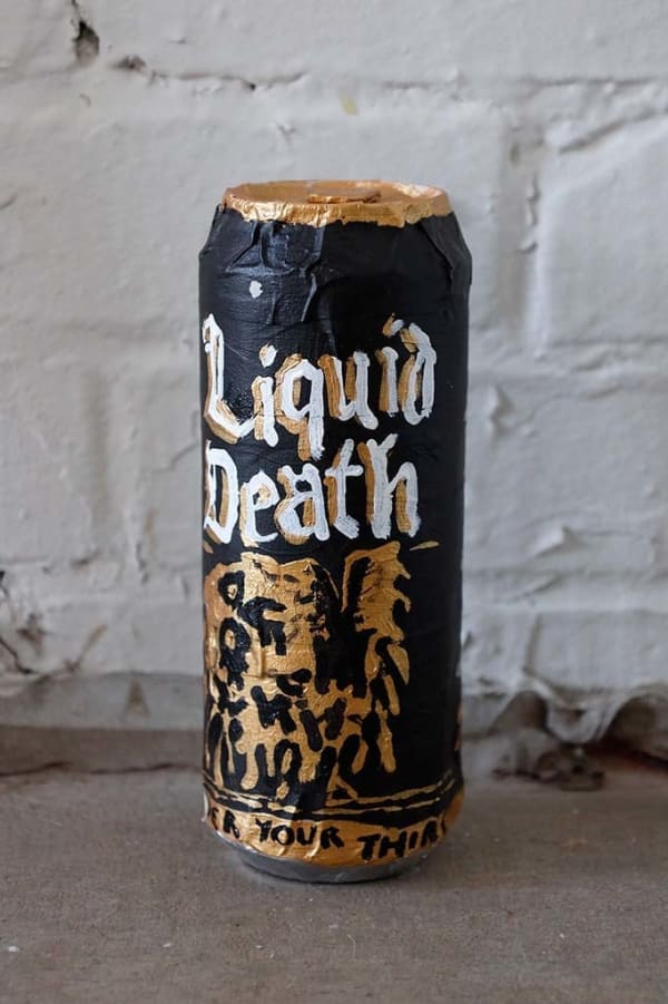 Soft sculpture of a Liquid Death can