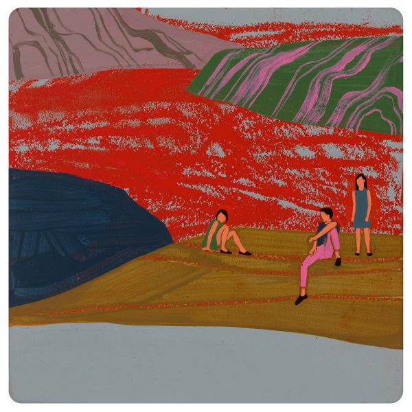 two woman sitting down and one woman standing on rocky terrain