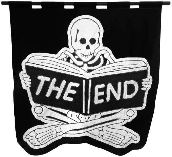 embroidered black and white banner of a skeleton sitting cross legged reading a book