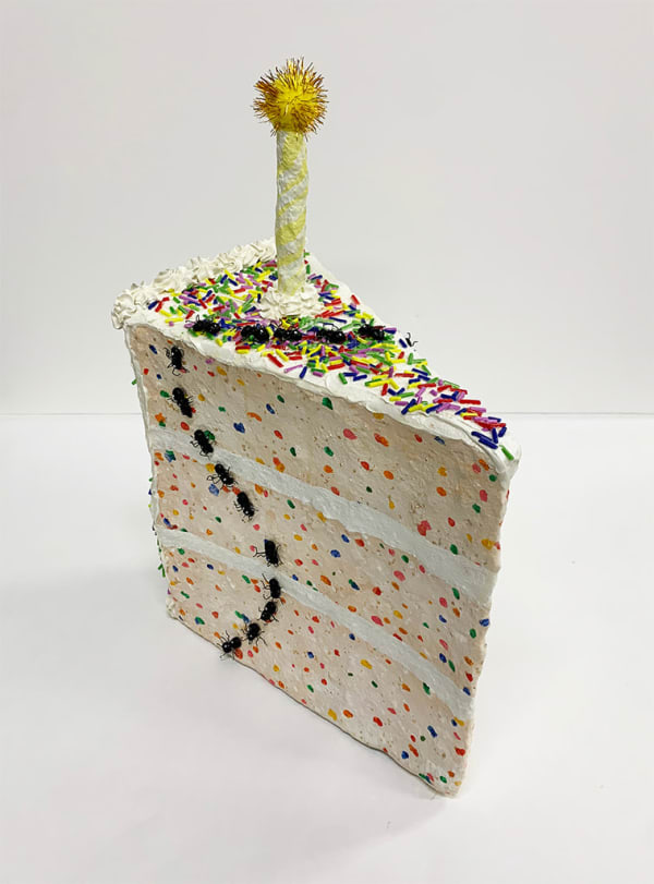 Nic Dyer mixed media sculpture of confetti cake slice with birthday candle, trail of ants on outside