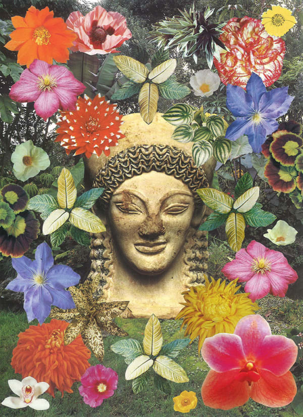 yellow statue head/bust surrounded by colorful flowers