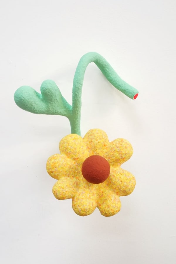 yellow flower sculpture supported by green stems