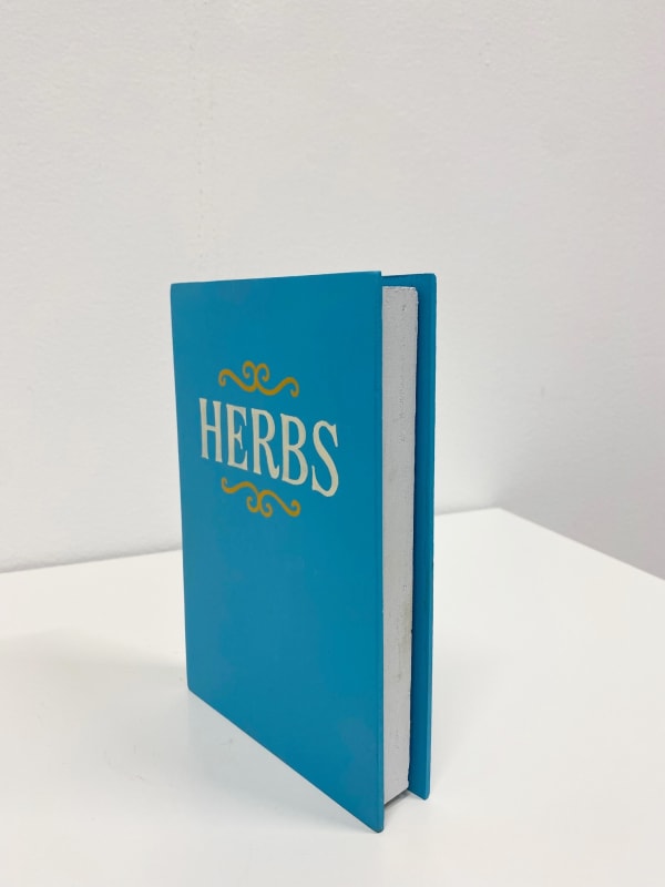 blue book with "Herbs" written on the cover