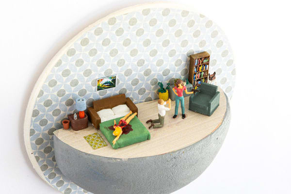 miniature diorama by Abigail Goldman of a naked woman bleeding out on a bed next to a man begging on his knees and another woman with a gun