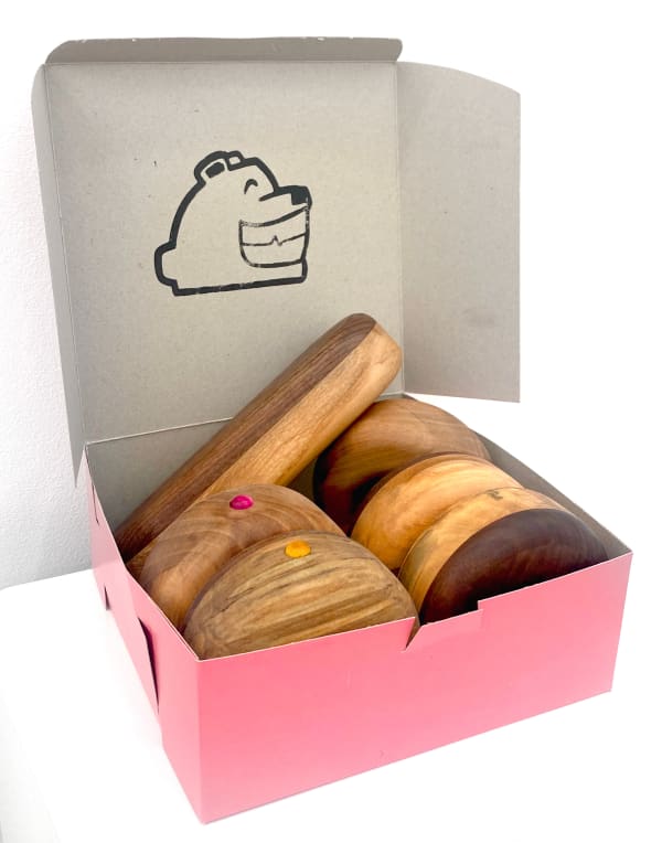 Lap Ngo wooden sculptures of assorted doughnuts in pink box with custom ink stamp print