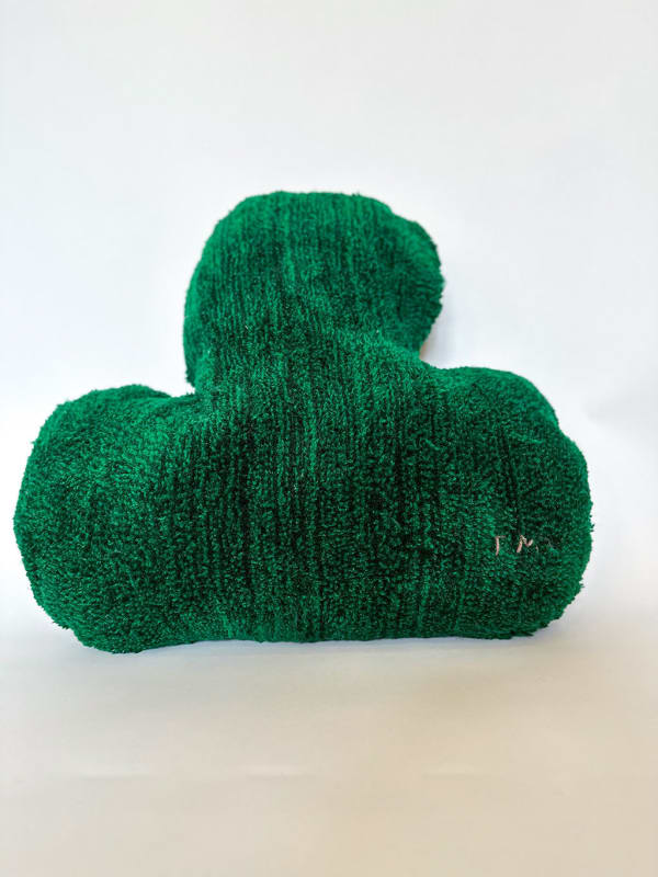 Soft sculpture of a dark green leaf