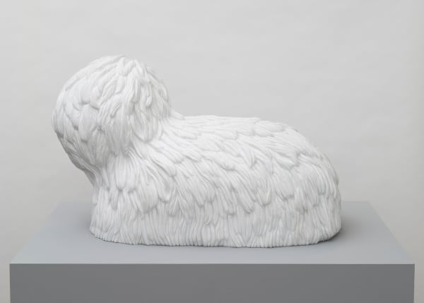 Free-standing, white marble sculpture in the form of a poodle-like creature whose entire surface is carved to give it fur-like texture.