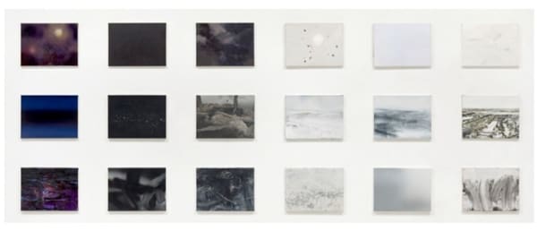 18 small rectangular panels arranged in a grid of three rows and six columns. Each panel has a distinct abstract or landscape scene. Panels on the left are black and dark gray (night) and panels on the right are white and light gray (day). Together the panels make a singular abstract landscape composed of sky on the top row, horizon in the middle, and earth on the bottom row.