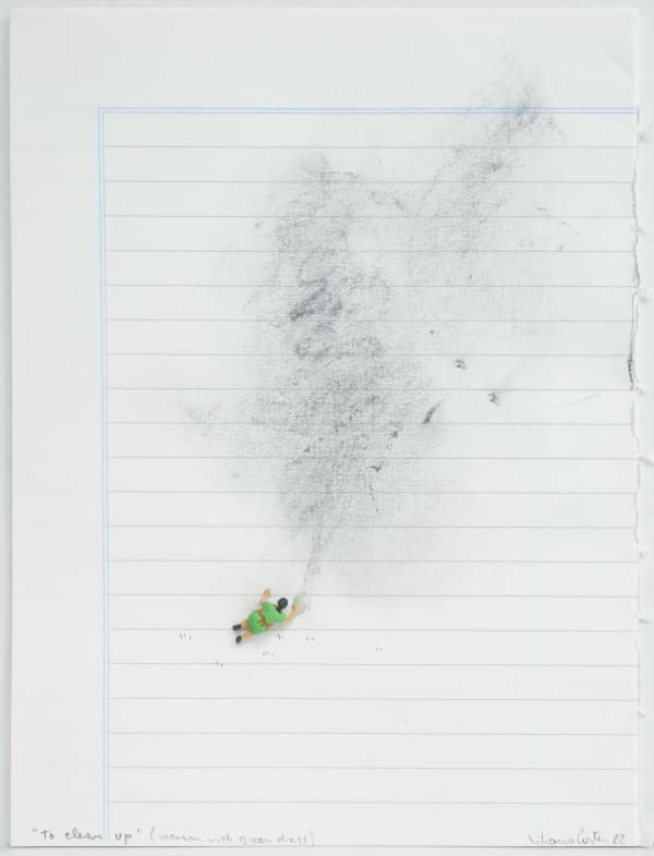 Figurine attempts to clean comparatively massive smudges of graphite on lined paper