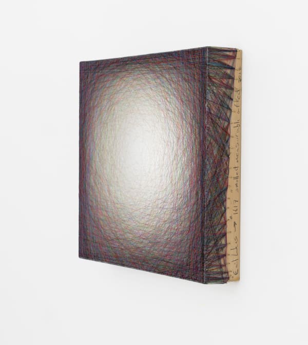 Layers of multi-colored threads strung across a square wooden and plaster panel create the effect of a white glowing center that is encircled by a dark maroon border