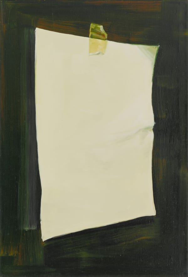 Blank piece of white paper, slightly crumpled, that is taped to a dark wall.