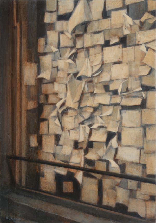 Small tan pieces of paper almost completely fill a window frame. The scene is cropped so that only the bottom left corner of the window is visible.