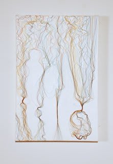 Five different strands of fine multi-colored thread pasted onto a white painted canvas At the ends of the strands the threads spread out in swirls and coil