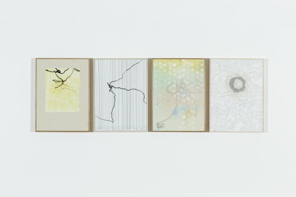 Four mixed media panels aligned horizontally which each contain winding trails either in black motor oil or dark thread Three of the panels also contain faded colors while the other is presented in grayscale