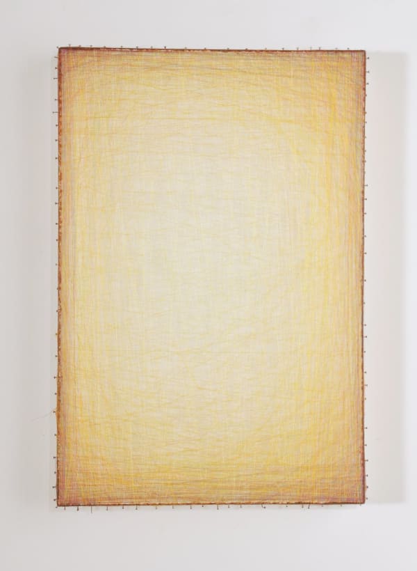 Layers of multi-colored threads strung across a rectangular wooden and plaster panel create the effect of a large glowing light yellow center that is enclosed by a more saturated yellow border